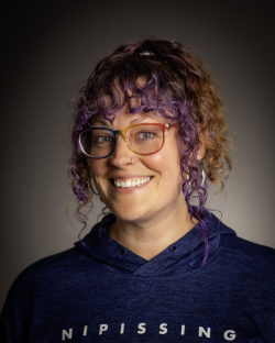 A woman headshot picture with nature background