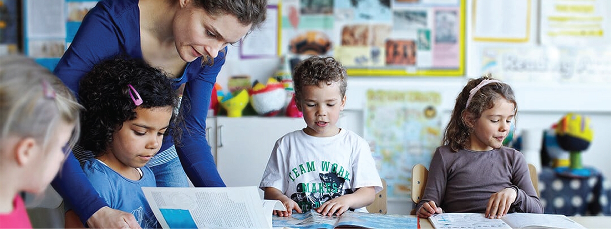 A teacher helping her students