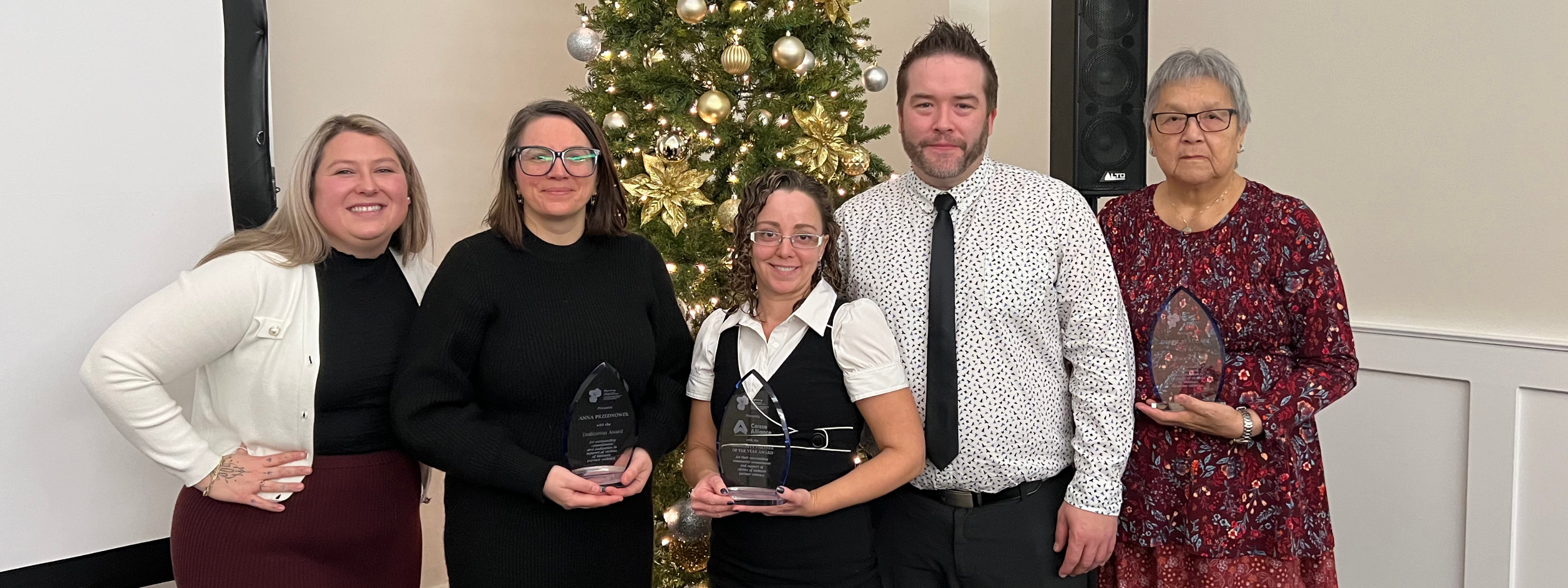 VAWCC Award Recipients stand in front of a holiday tree. 