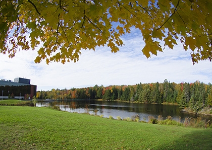 Beautiful photo of the pond on campus during fall colours