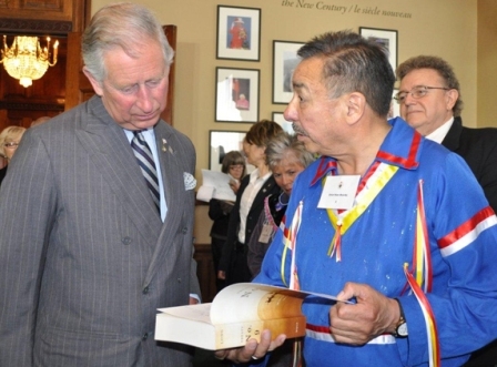 Photo of Prince Charles being presented with a copy of Treaty No. 9