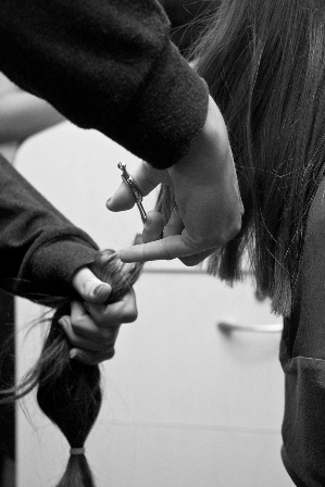 Black and white photo of someone cutting hair