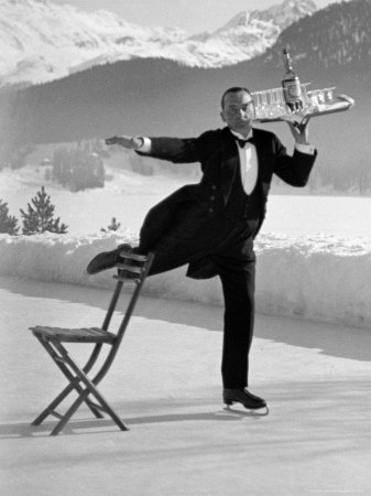 Black and white photo of a skating butler balancing champagne and glasses on a tray