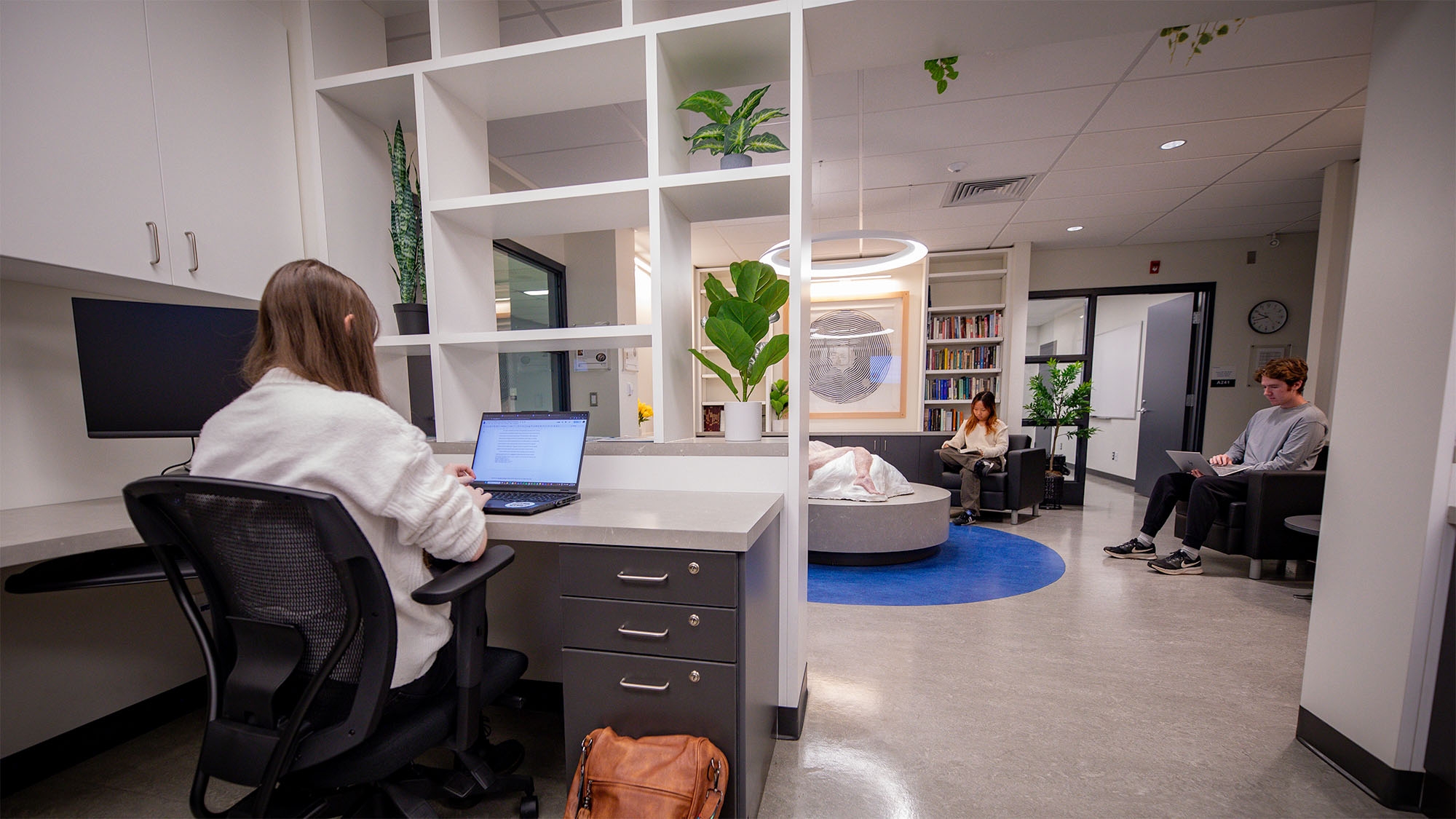 C-WAG space with 3 students doing work and reading books inside