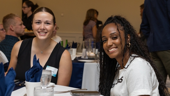 Nakissa Koomalsingh at table with guest