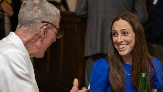 Mabel Plourde-Doran, Distinguished Alumni Achievement Award winner at dinner table