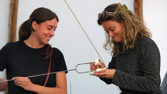 Roasting marshmellows in the Library Teepee during Homecoming weekend