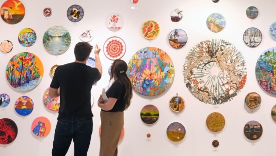 Two Lakers enjoying art exhibition during NU Homecoming 2025