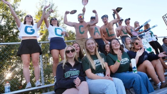 Lakers cheering during games, people in the back row have letters "GO CALLUM" written on them