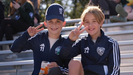 Two young boys posing for a photo during NU Homecoming 2025