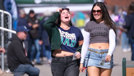 Two Lakers enjoying a walk together during NU Homecoming 2025