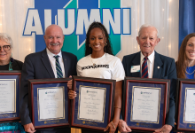 The 2024 Alumni Award recipients stand with their awards.