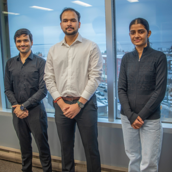 Sagar Tewatia, Keshav Singh and Lovepreet Kaur stand together in the boardroom